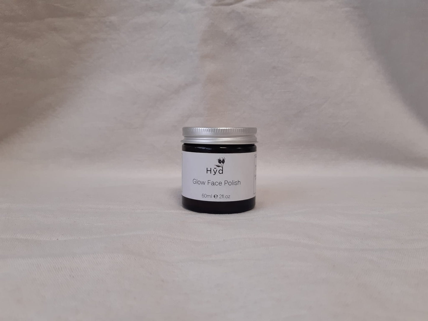 Jar of Hyd Glow Face Polish on a grey background