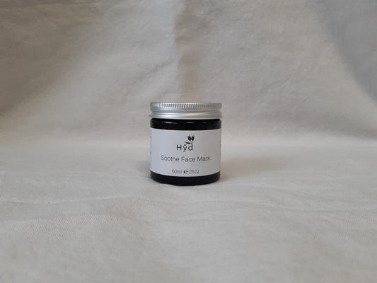 Jar of face mask labeled 'Hyd' on a gray background
