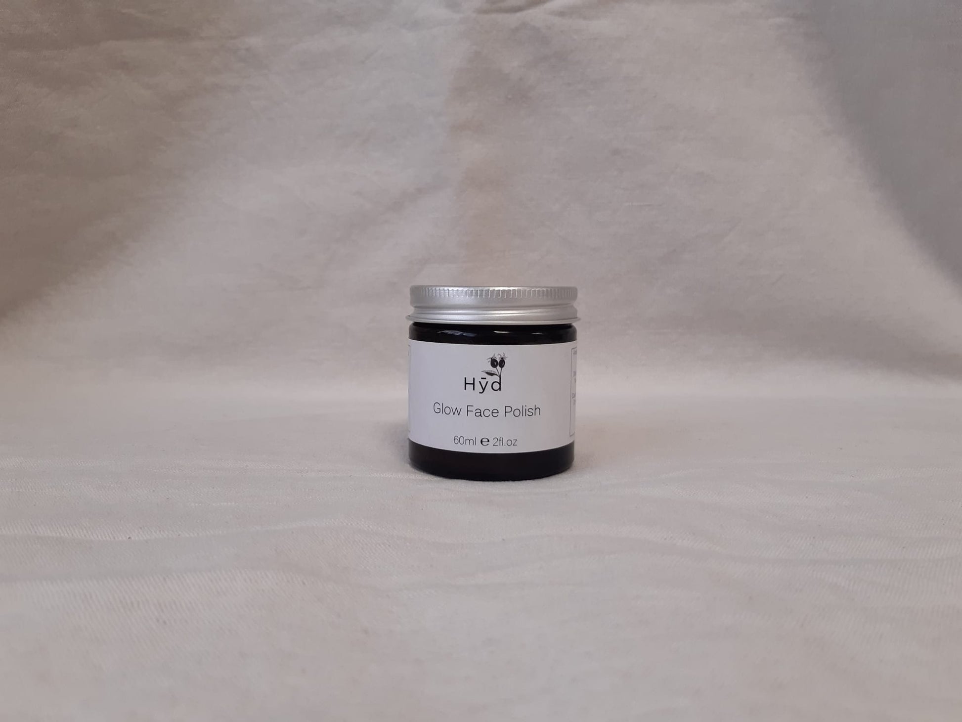 Jar of Hyd Glow Face Polish on a grey background